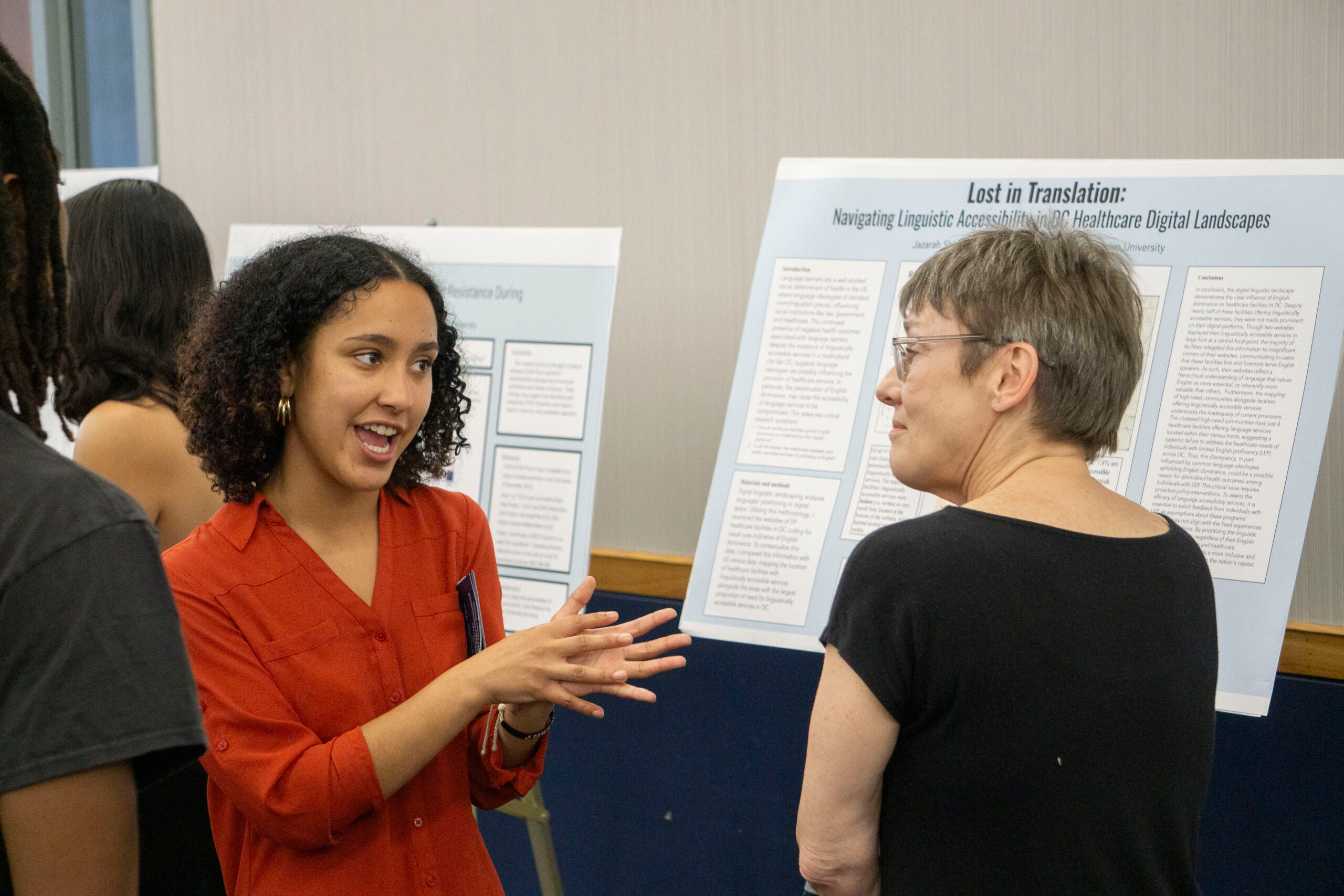 Senior Jazarah Shim talks with Professor Sarah Stiles about their senior thesis presentation, gesturing with their hands