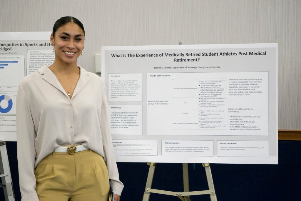 Senior Jazmyn C Harmon poses in front of their presentation
