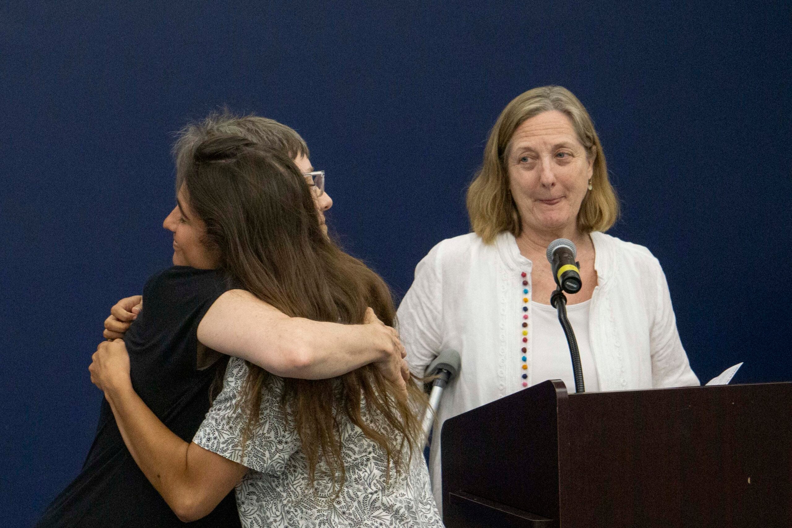 Senior Erin Farrell hugs Professor Stiles while receiving AKD award