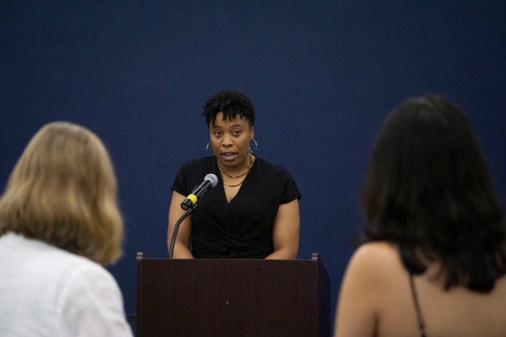 Professor Carla Shedd delivers her remarks to the sociology seniors from a podium